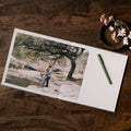Layflat photo book open flat with a couple photo printed across the spread