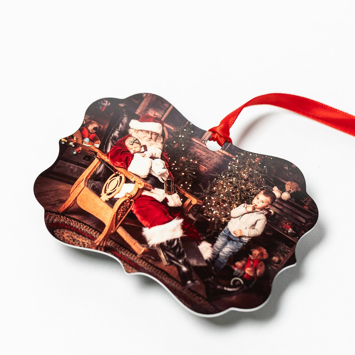 Personalized metal photo ornament with a family Christmas photo and red ribbon