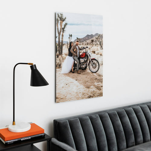 Acrylic print of a couple hanging above a gray couch