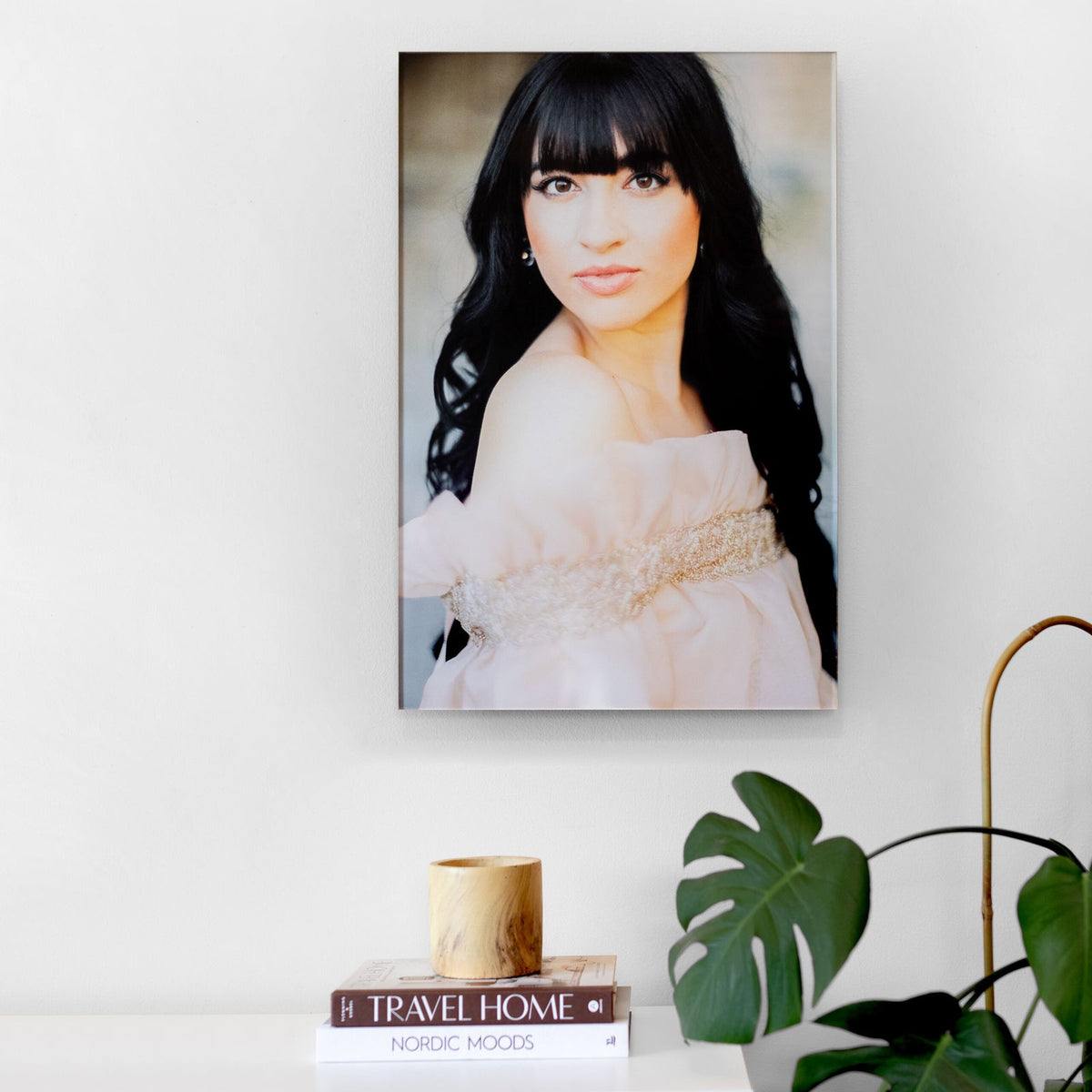Acrylic portrait print hanging on a white wall