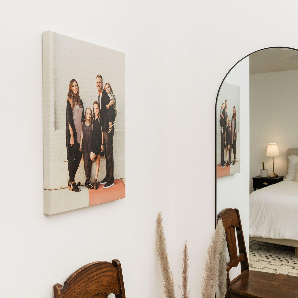 Gallery wrap family portrait hanging in a bedroom