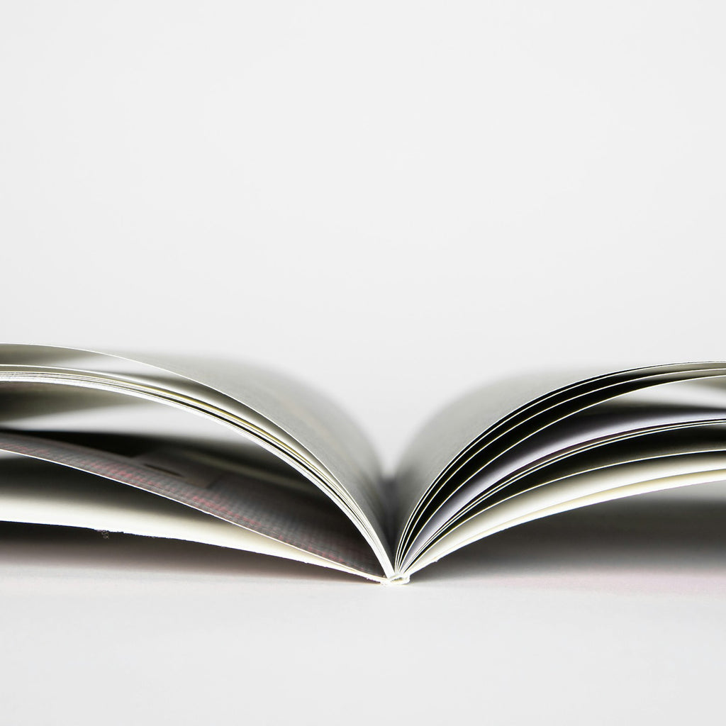 Softcover photo book open showing the flexible binding