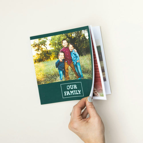 Hand opening a softcover photo book